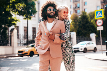 Beautiful fashion woman and her handsome elegant boyfriend in beige suit. Sexy blond model in...