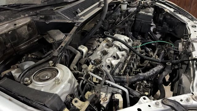 Close-up of the engine of a disassembled truck in the mechanical workshop. Waiting for repairs.