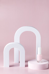 Composition from Pink nail polish bottle on the podium Pink Bright background Festive Cosmetic Concept Minimal Vertical