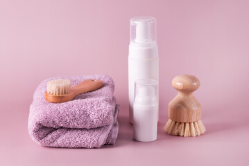 Blank cosmetic packaging mockup Jar of face foam and towels on Pink Background