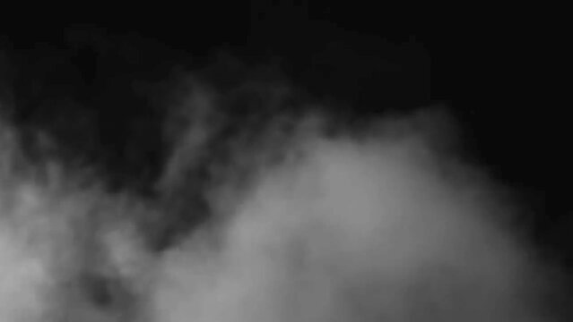 Abstract  smoke in slow motion. Smoke, Cloud of cold fog in light spot background. Light, white, fog, cloud, black background, 4k, ice smoke cloud. Floating fog.
