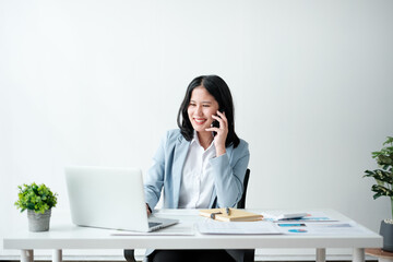 Portrait of smile beautiful business asian woman in blue suit working office desk computer. Small...
