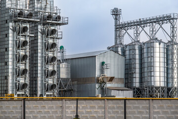Fototapeta na wymiar silos and agro-processing plant for processing for drying cleaning and storage and seed preparation complex