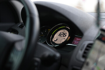 speedometer of a car with regulator indicating 126 km hour