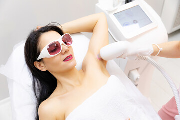 Armpits laser treatment. Close up shot of a young woman having armpits hair removed with a laser...