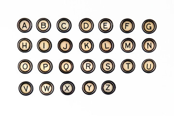 Alphabet of vintage fridge magnets styled on typewriter keys isolated over a white paper background