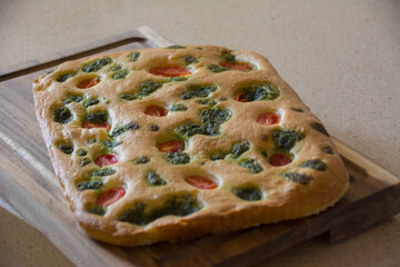 Home made focaccia with cherry tomatoes and basilica   