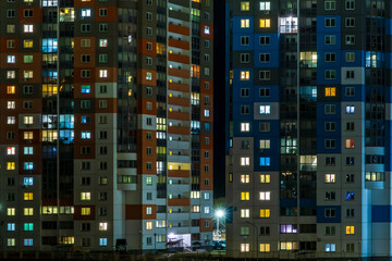 Fototapeta na wymiar with light in windows of multistory buildings at night. life in a big city. Serenade of light