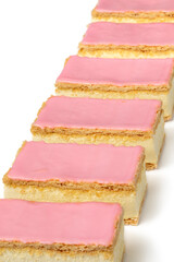 Fresh baked traditional Dutch Tompouce pastry in a row on white background close up