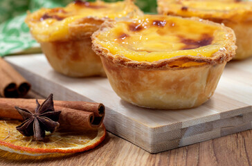 Lots of desserts Pastel de nata or Portuguese egg tart and cinnamon sticks. Pastel de Belm is a small pie with a crispy puff pastry crust and a custard cream filling.