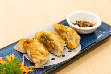 Shanghai fried mini dumpling, served with black vinegar dips in Chinese dim sum restaurant