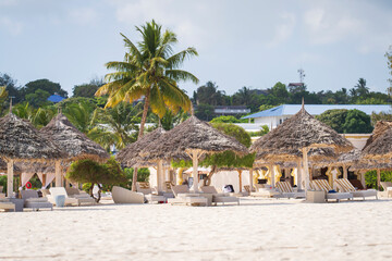 Luxury beach loungers and umbrella at luxurious beach resort