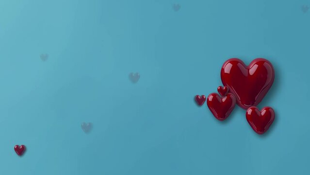 floating valentine glass hearts on light bule background