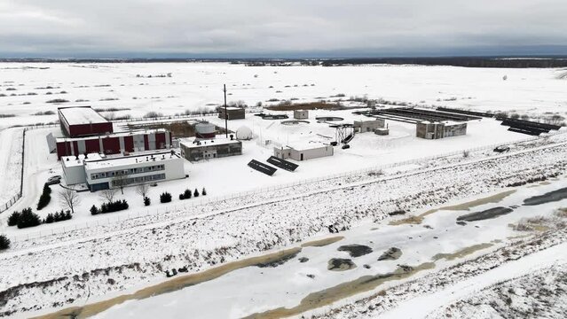 Snow covered water treatment plant location, winter in Silute, Lithuania, drone flight
