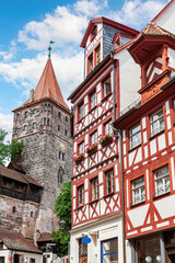 Obraz premium The half-timbered building and the white stone tower. Nuremberg, Bavaria,Germany.