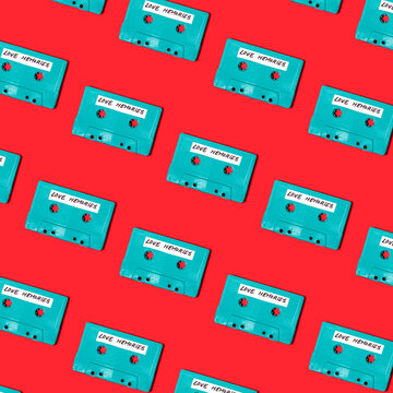 Collection of retro cassettes arranged on red surface
