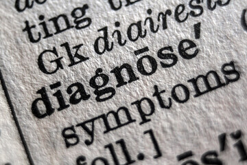 Word “diagnose” printed on dictionary page, macro close-up
