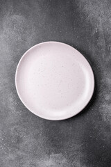 Empty round ceramic plate on a light texture background
