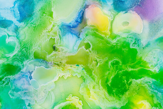 Vibrant abstract fluid art pattern with green hues