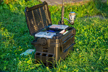 A large fisherman's tackle box fully stocked with lures and gear for fishing.fishing lures and...
