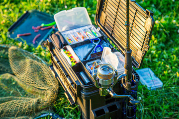 A large fisherman's tackle box fully stocked with lures and gear for fishing.fishing lures and...