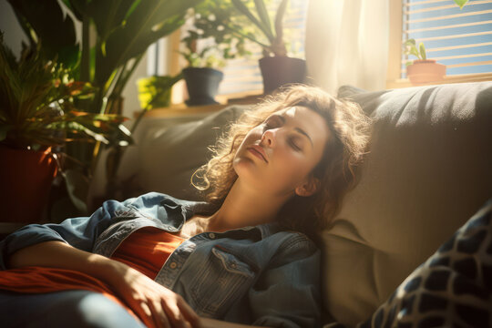 Tranquil Living: A Young Woman Relaxing on a Comfortable Sofa in a Cozy, Serene Home.