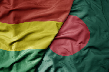 big waving national colorful flag of bangladesh and national flag of bolivia .