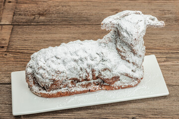 Easter lamb cake with traditional spring decor. Baked sweet dessert with icing. Festive background