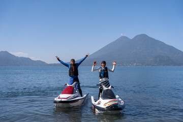 Young Hispanic Men Posing on Jet-Skis with Arms Up at Atitlan Lake, Guatemala
