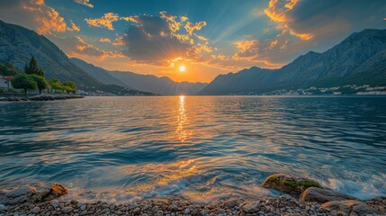Realistic photo capturing the majestic Bay of Kotor with the sun setting behind scattered clouds, casting a warm golden glow over the tranquil waters, waves gently kissing the rocky shore, Generative  - Powered by Adobe