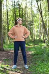 Woman with headphones exercising outdoor in the park. Sport activity lifestyle