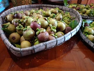 baskets of fresh vegetables Mangosteen, a sweet, purple fruit from a Thai garden.