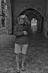 a woman standing in a tunnel with a hat on