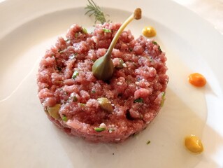 raw red minced beef with spices and giant caper