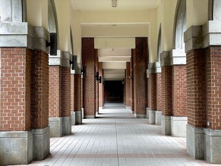 In the library building's corridor, the colonnade of rounded arches extends forward.