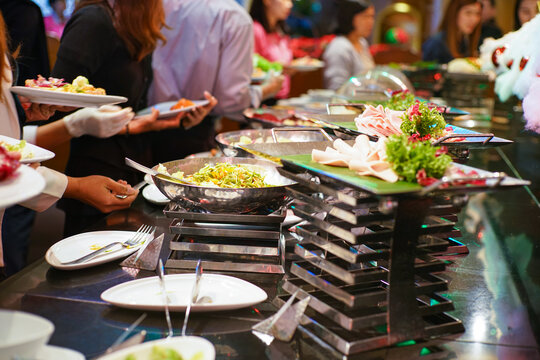 People seminar group hand grab buffet food in restaurant after seminar