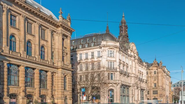 Historical houses on Lenbachplatz square timelapse in Munich, Germany. Traffic on the street and rails with trams. Sunny day with blue sky