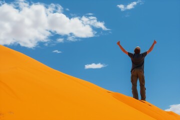 Fototapeta na wymiar visitor with arms raised on a dune summit