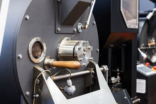 Industrial coffee roaster close-up photo, roastery of specialty coffee