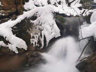 Mountain stream in winter. Ice and snow on a beautiful mountain creek