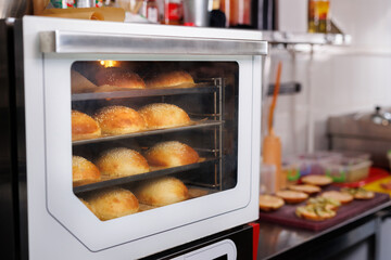 Burger buns are baked in the oven in the restaurant kitchen.
