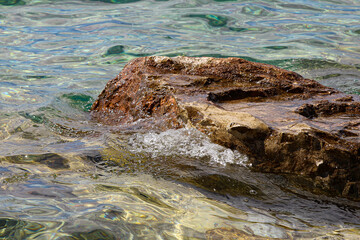 Blue Mediterranean Sea. Clear Water. Stones at the Bottom of the Mediterranean Sea.  Small Waves.