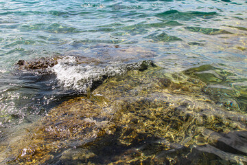 Blue Mediterranean Sea. Clear Water. Stones at the Bottom of the Mediterranean Sea.  Small Waves.