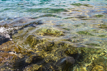 Blue Mediterranean Sea. Clear Water. Stones at the Bottom of the Mediterranean Sea.  Small Waves.