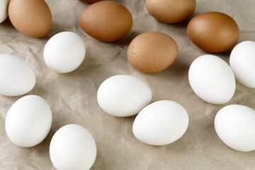 White and brown eggs on the table. View from above