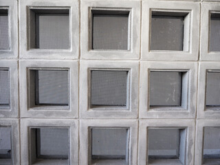 Ventilated block panel with safety net installed on a concrete wall.