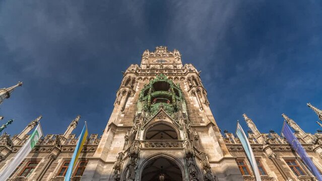 Clock Tower or Glockenspiel close-up, section of bell play timelapse, Munich, Germany. Looking up perspective. Detail of Rathaus New Town Hall with chime in city center. Located on Marienplatz square