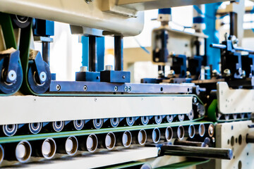 A industrial commercial envelope making machine, making paper envelopes for international distribution. Automated engineering machinery for mass production of paper envelopes.