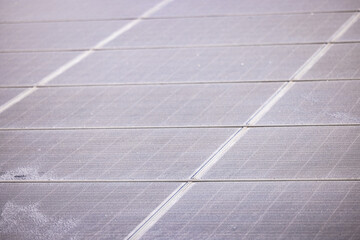 Individual iced solar panels of a PV system for the energy crisis exposed in sunlight