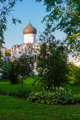 Fototapeta premium Pskov, Russia, September 6, 2023. Garden in front of an ancient Orthodox church.